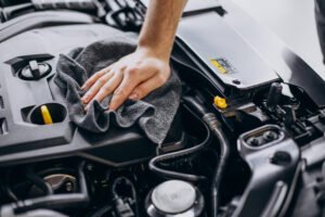 man polishing car inside at car service